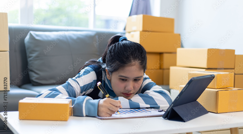 A young Asian woman who started an online business at home is discouraged. A young Asian woman who started an online business at home is discouraged.