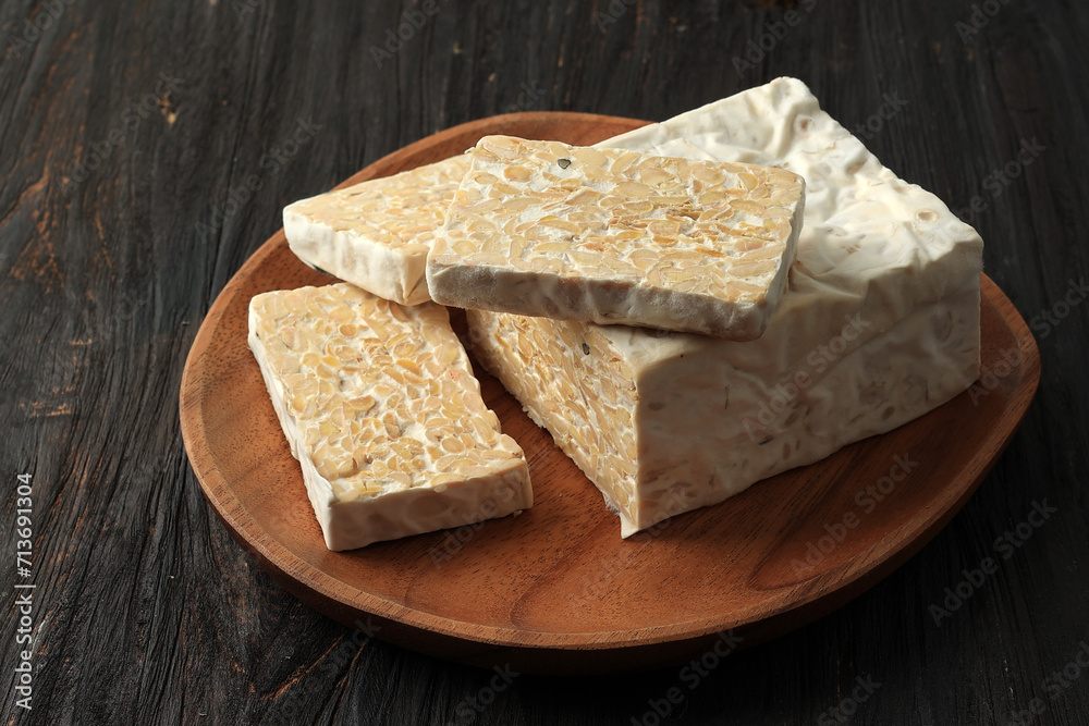 Sliced Tempeh, Fermented Soybean. Servde on Wooden Plate