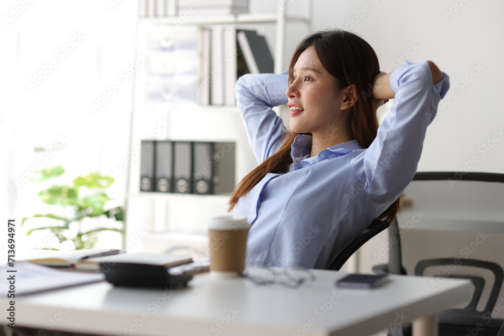 Asian woman working in office stretching relaxation during break to relieve fatigue. Asian woman working in office stretching relaxation during break to relieve fatigue.