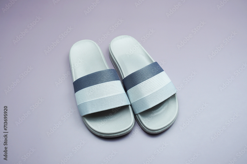 Gray slide sandal summer slippers on purple background Gray slide sandal summer slippers on purple background