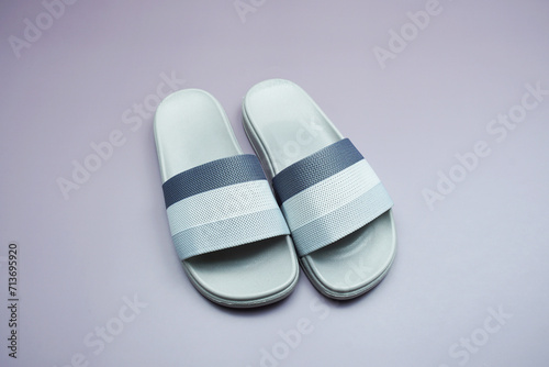 Gray slide sandal summer slippers on purple background