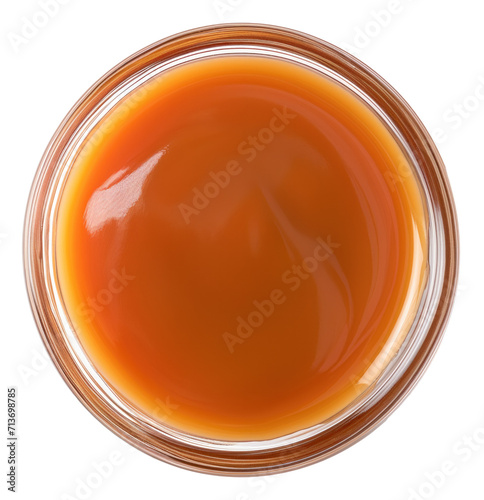 Sweet caramel sauce in bowl isolated.