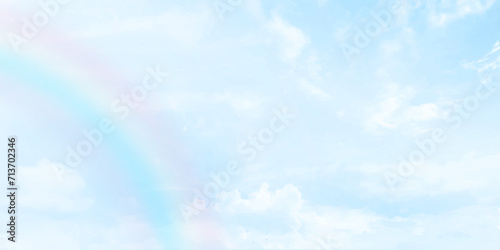 Rainbow on blue sky with Clouds painted on canvas. Picturesque view of beautiful rainbow and blue sky on sunny day