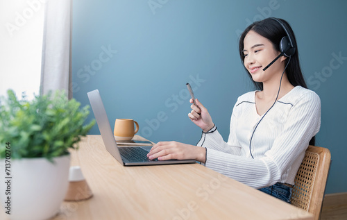 Portrait of nerd sme business asian woman work from home at headphone online computer desktop table Beauty Asia freelancer girl using laptop in bed room. Small business sme digital network  technology