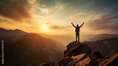 Happy man raising his arms jumping to the top of the mountain, successful businessman celebrating success on the cliff, business success concept silhouette backlit. © Phoophinyo