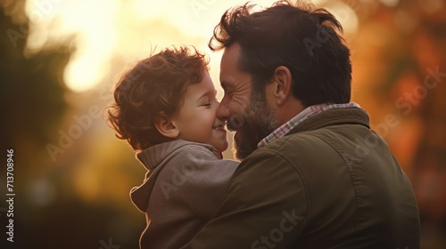 Father, bonding kiss and boy child hug happy in nature with quality time together outdoor. Happiness, laughing and family love of a dad and kid in a park enjoying nature hugging with care and a smile.