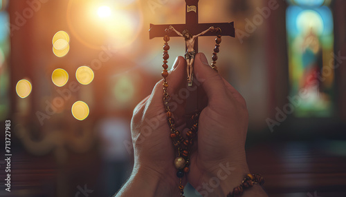 close up hands holding a rosary while praying in church © santima