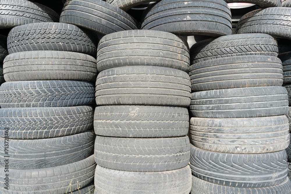 Old used tires stacked with high piles Old used tires stacked with high piles