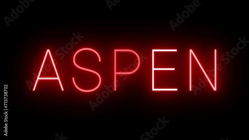 Flickering red retro style neon sign glowing against a black background for ASPEN