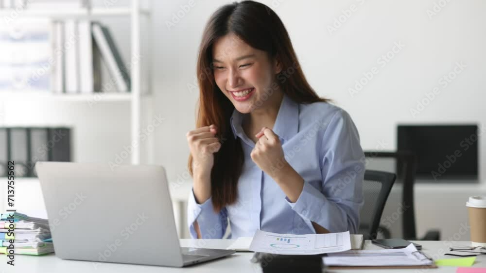 Asian woman using laptop is excited and happy. Asian woman using laptop is excited and happy.