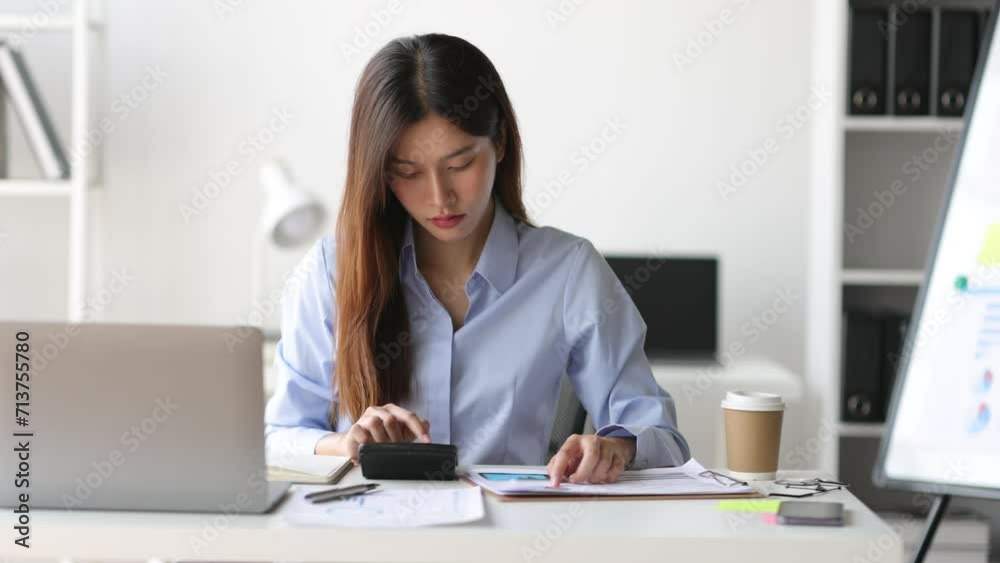 Businesswoman reading documents while working on accounting paperwork and analyzing financial budgets in the office. Businesswoman reading documents while working on accounting paperwork and analyzing financial budgets in the office.