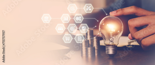Hand choose light bulb with bright and icons for creative idea concept or innovation of technology in analyzing global marketing online business data management services to target growth concept. photo