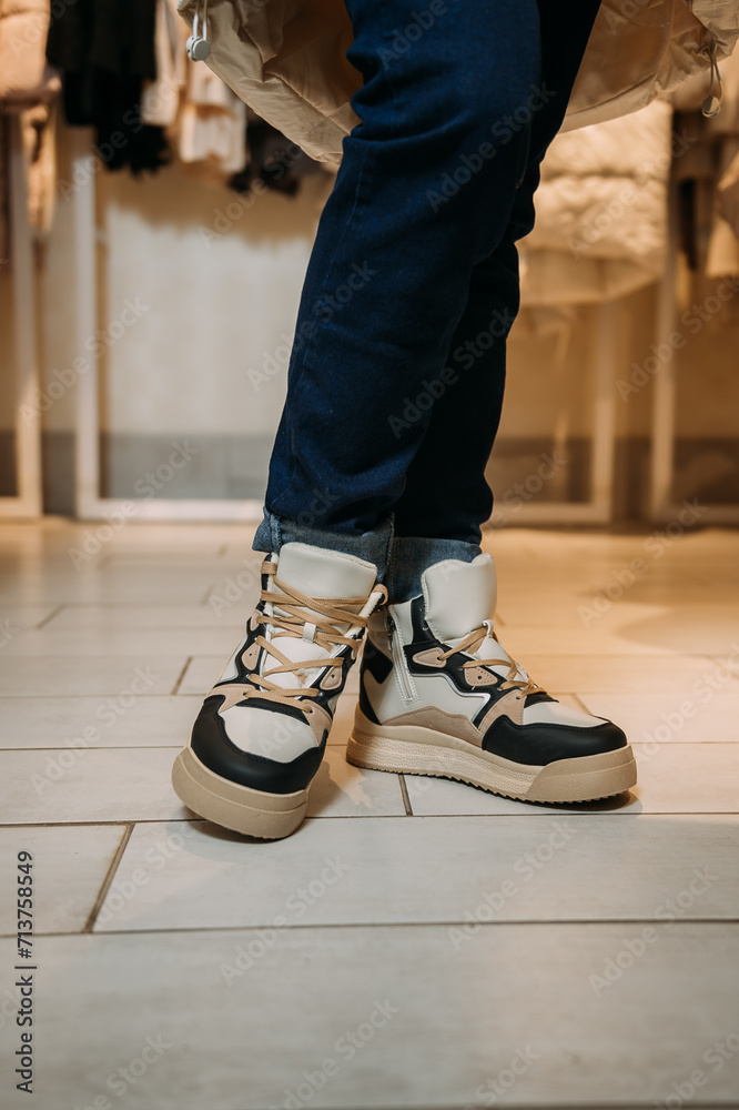 A persons legs wearing shoes, specifically sneakers or walking shoe 5869s. A persons legs wearing shoes, specifically sneakers or walking shoe 5869s.