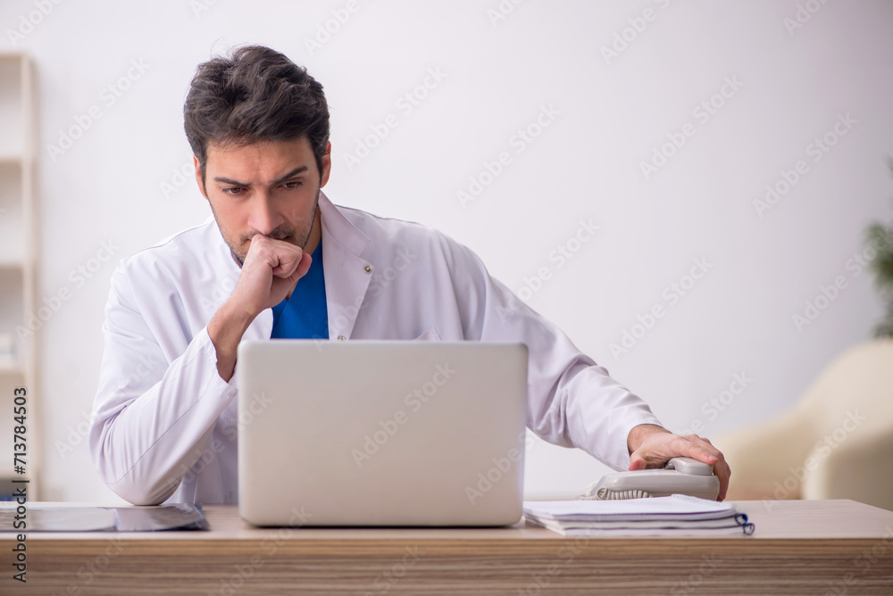 Young male doctor in telemedicine concept Young male doctor in telemedicine concept