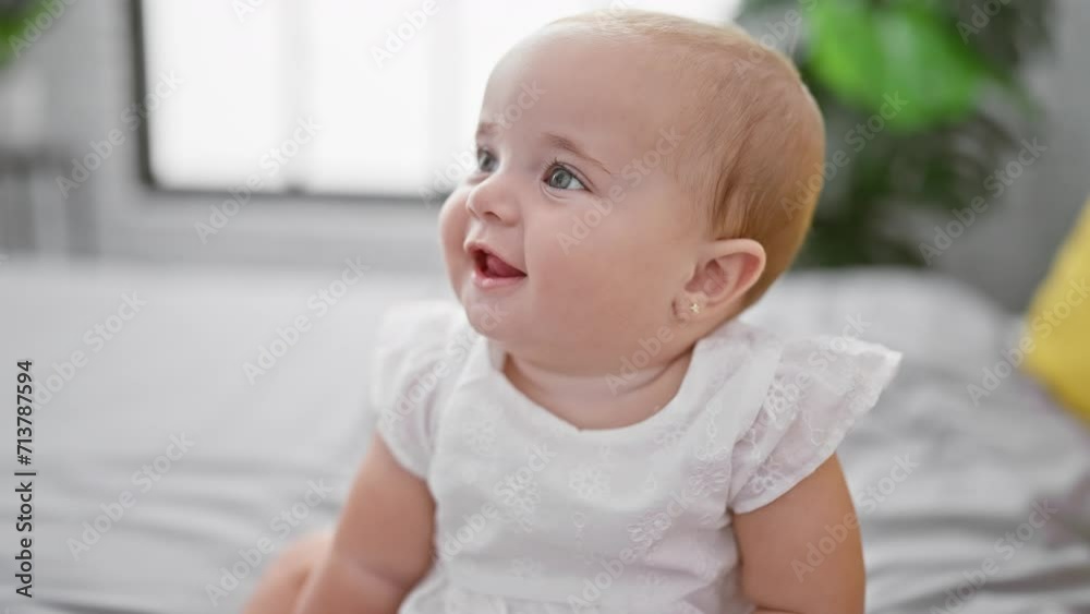Adorable newly awake baby relaxed, sitting on bed, smiling broadly in cozy bedroom comfort Adorable newly awake baby relaxed, sitting on bed, smiling broadly in cozy bedroom comfort