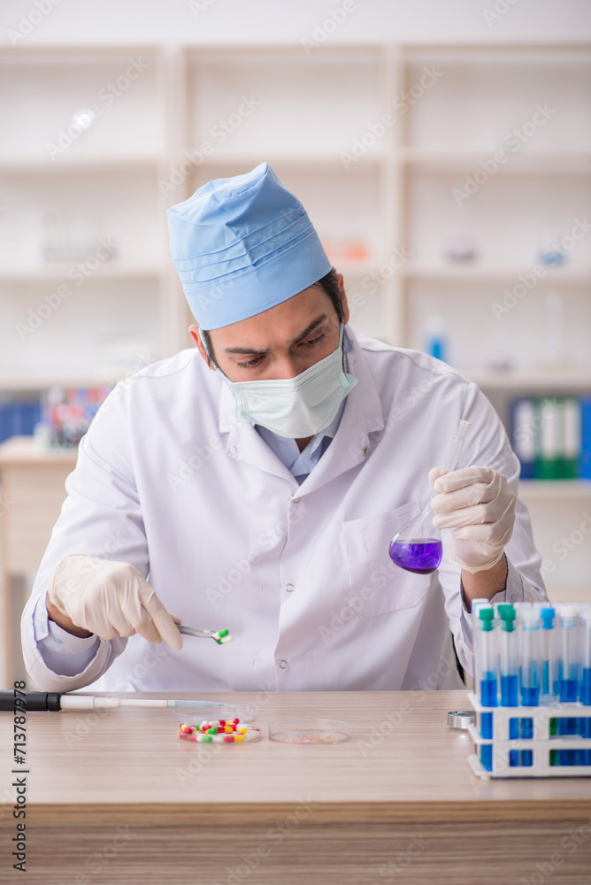 Young male chemist working at the lab
