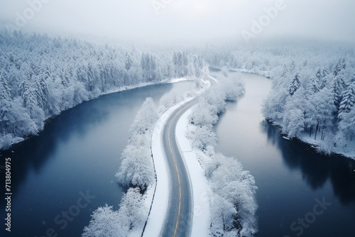 Asphalt road in snow near lake in winter season
