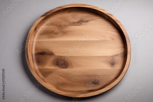 Wooden plate on gray background. Top view with copy space.