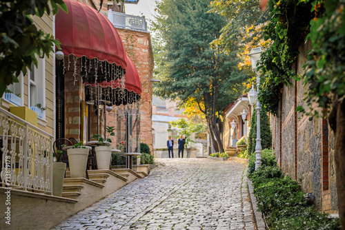 Soguk Cesme Sokak, small car free cobblestone street with historic houses in Sultanahmet, between Hagia Sophia and Topkapi Palace, Istanbul, Turkey photo