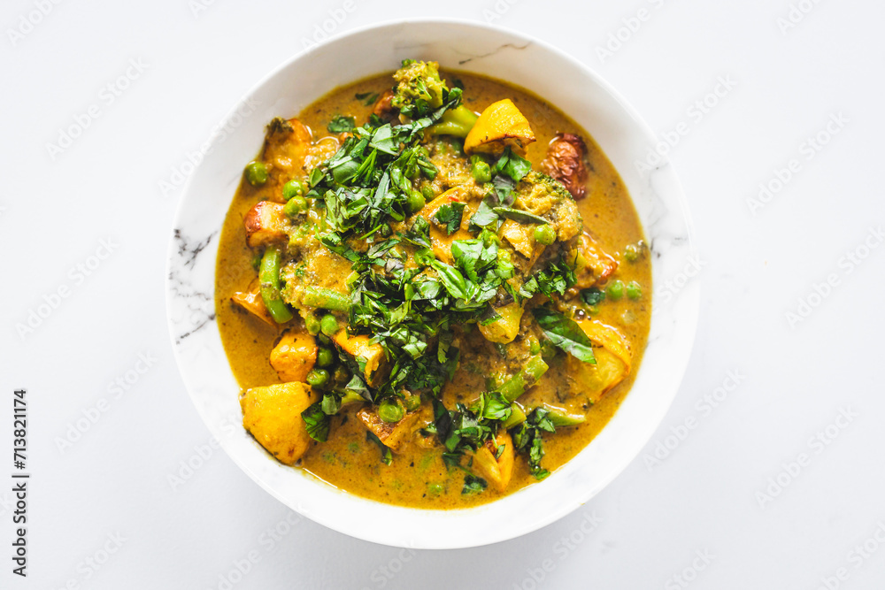 plant-based potato and vegetable green curry with fresh herbs plant-based potato and vegetable green curry with fresh herbs