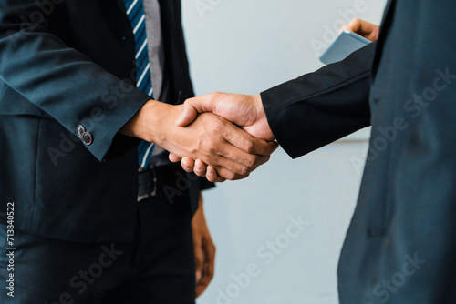 Business people agreement concept. Businessman do handshake with another businessman in the office meeting room. uds © Summit Art Creations