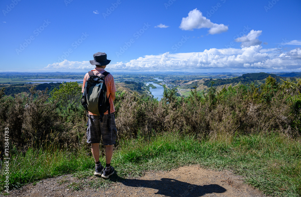 Hiking Hakarimata Summit Track. Man enjoying the views of Huntly and Waikato river. Huntly. New Zealand.