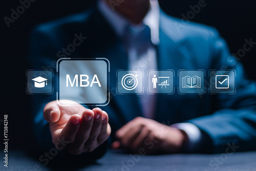 MBA or master of business administration program concept. Businessman holding virtual MBA icons for personal development. photo