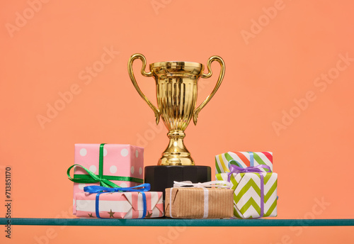 Winning the competition. Colorful gifts and a trophy. © Dima