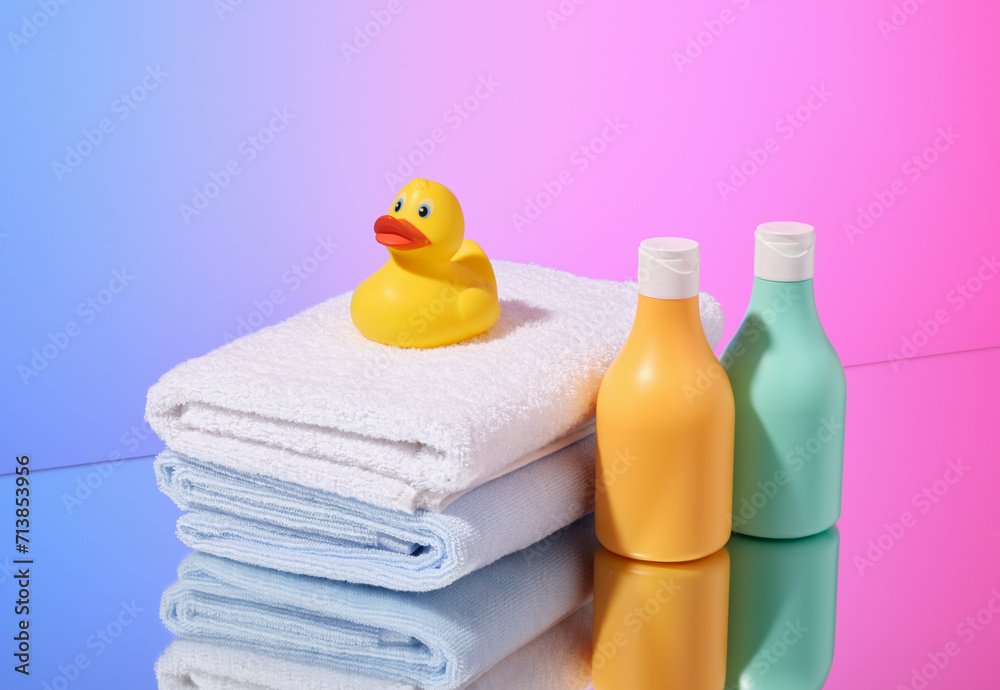 Shower gels, towels and a yellow rubber duck. Baby care and hygiene accessories. Shower gels, towels and a yellow rubber duck. Baby care and hygiene accessories.