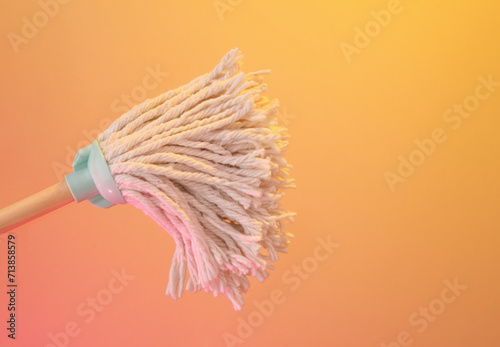 A white mop for mopping the floor. Copy space for text.