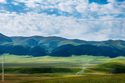 Traditional summer pasture in the mountains of nomadic peoples of Asia. Yurt on a pasture. Assy plateau. Kazakhstan