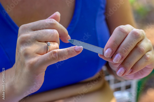 Manicure in Nature. Close up View of Woman with Nail File