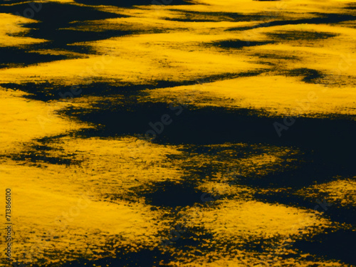 Yellow black abstract background reminiscent of clouds over a black bottom, top view. Accumulations of yellow smoke or powder on a dark base. Generated by AI photo