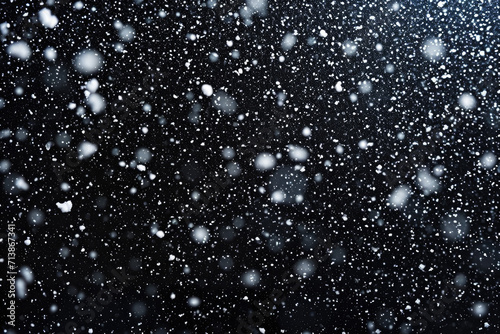 Falling snow on black background photo