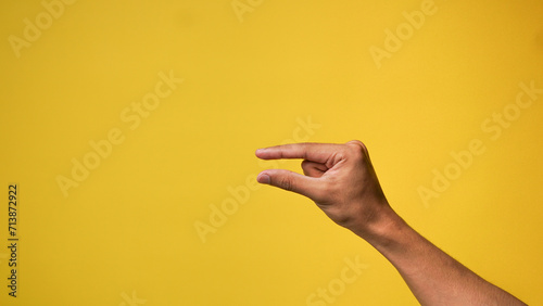 Men's hands with small gestures on a yellow background
