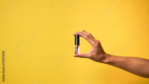 Men's hands give a love gesture on a yellow background
