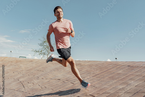Energetic man enjoying a vibrant run in open air.