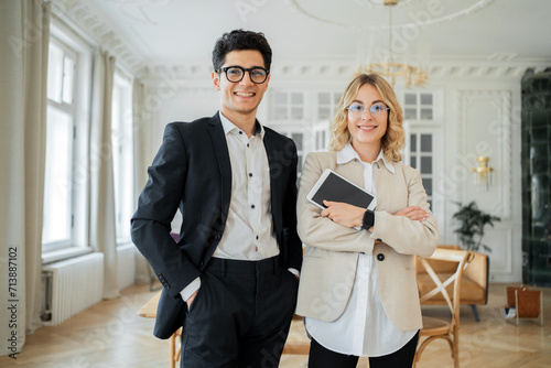 Confident managers professional team with digital tablet in an upscale office.
