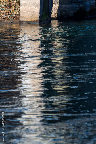 Reflection in the water. Concrete pillar. Abstract art. River Bregalnica, Macedonia 2024