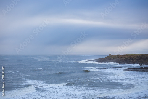 House on a cliff next to wild sea
