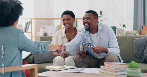 Home, couple and insurance agent with documents, handshake and conversation in a living room. People, man or women with paperwork, shaking hands or real estate with planning, consultation or property photo