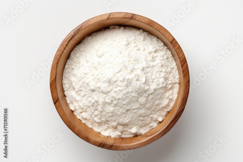 Top view of rice flour in wooden bowl with rice ears isolated on white background photo