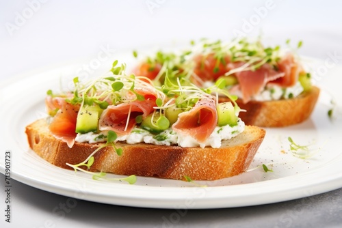 Vertical close-up of Antipasto Bruschetta on a white plate with baguette, bacon or meat, cream cheese, micro-greenery, cucumber, and sprouts, placed on a textured white background.