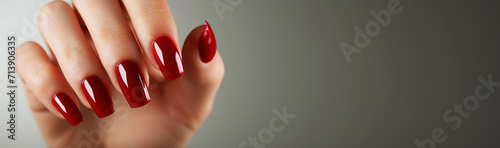 Fotografiet Woman hand with red nail polish on her fingernails