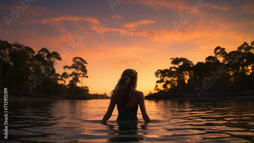 Dusk Serenity Dip - Woman Delighting in a Tranquil Swim in Nature s Lagoon  the Ultimate Natural Swimming Pool