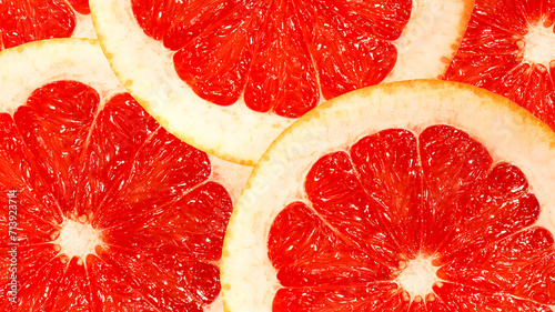Background of grapefruit slices close-up. Top view. Macrography. photo