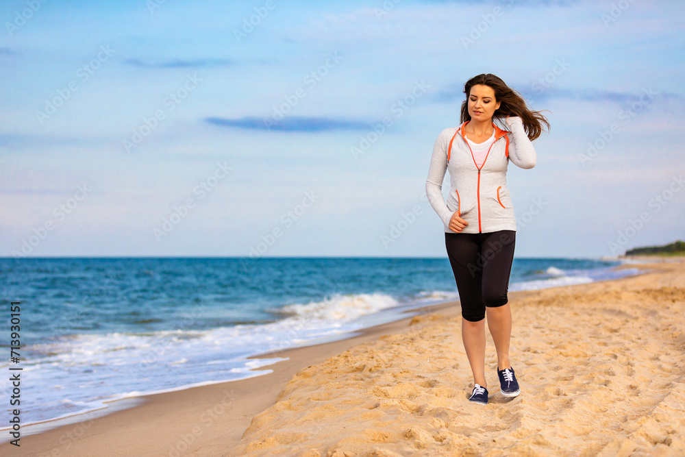 Beautiful mid adult woman walking on beach
Beautiful mid adult woman walking on beach