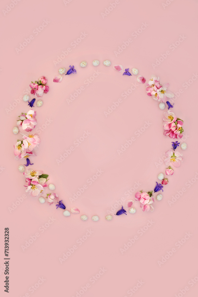 Floral wreath for Easter with mini eggs, bluebell flowers and apple blossom. Abstract design for card, logo, gift tag or invitation on pink background. Floral wreath for Easter with mini eggs, bluebell flowers and apple blossom. Abstract design for card, logo, gift tag or invitation on pink background.