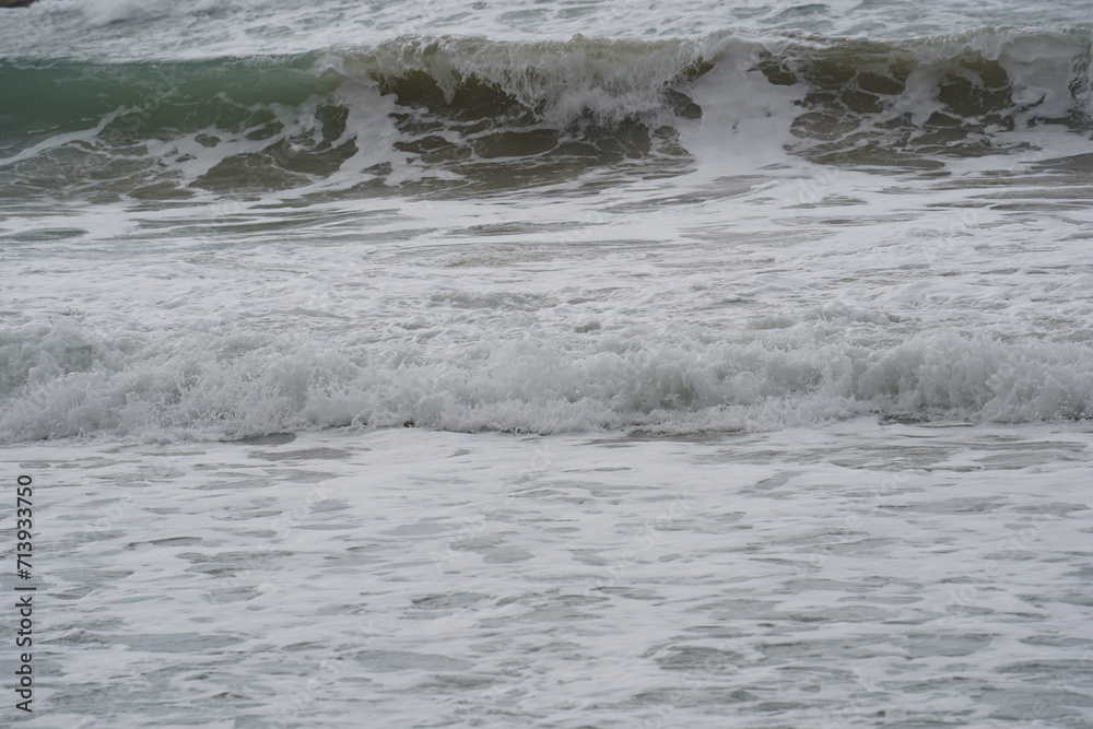 Mediterranean sea waves crushing on a sandy beach