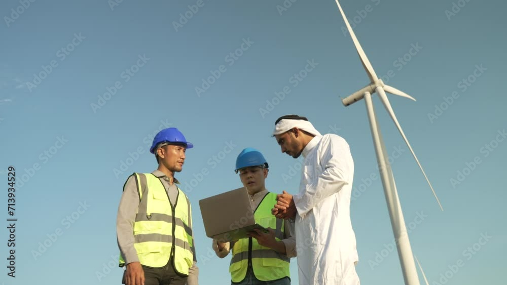 Blue collar workers are working at wind mill field for generated electricity. Blue collar workers are working at wind mill field for generated electricity.